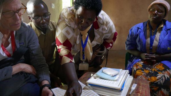Jody Lori, University of Michigan School of Nursing, reviewing teaching materials with community partners in Butaro District of Rwanda